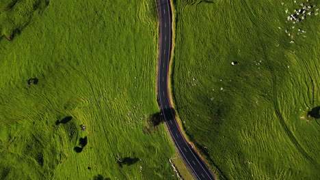 aerial top down of asphalted switchback road street in green hills countryside, clean environment natural energy no pollution concept aerial cinematic eye's bird view