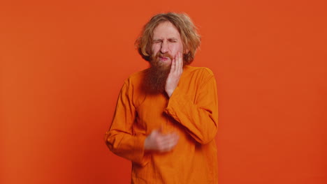 caucasian man touching cheek closing eyes with expression of terrible suffer from painful toothache
