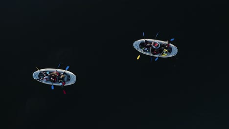 Drone-shot-directly-down-to-the-lake-with-two-boats-and-people