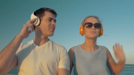 a lively dance of young people in headphones outdoor