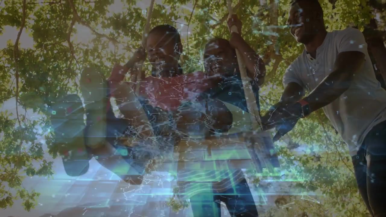 Woman steadying rope as man pushing swing, kids laughing beneath tree, teal overlay for marketing