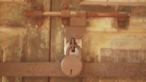 cinematic, revealing off focus to focus shot of an old lock on the door