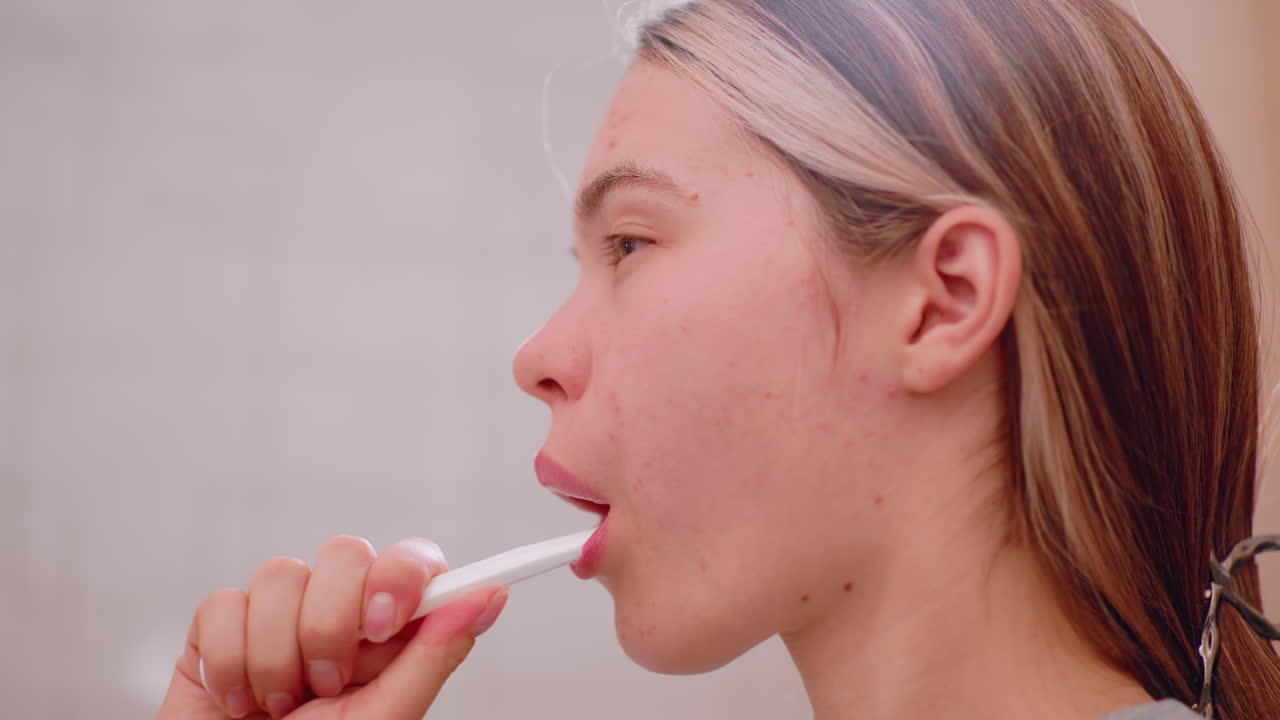 Close up side view of young woman brushing teeth with toothbrush, highlighting oral hygiene, dental care, morning routine, personal grooming, wellness, and lifestyle practices for clean healthy mouth