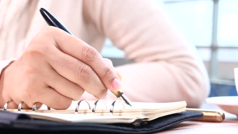 person writing in a notebook