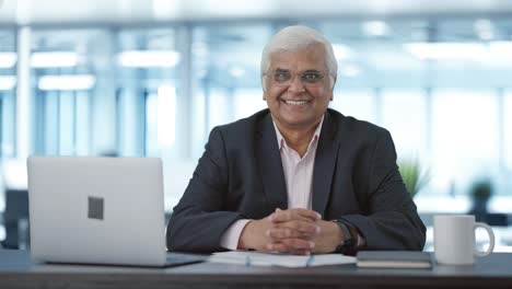 Happy-senior-Indian-businessman-smiling-to-the-camera