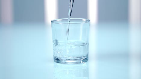 pouring water into glass. laboratory testing of water. clean water in glass