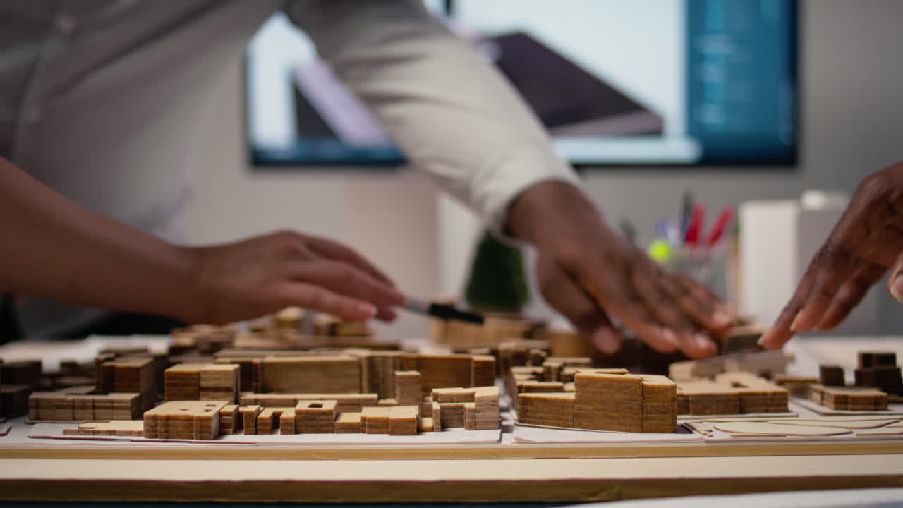 Close up of diverse developers focuses on 3D models layout presentations