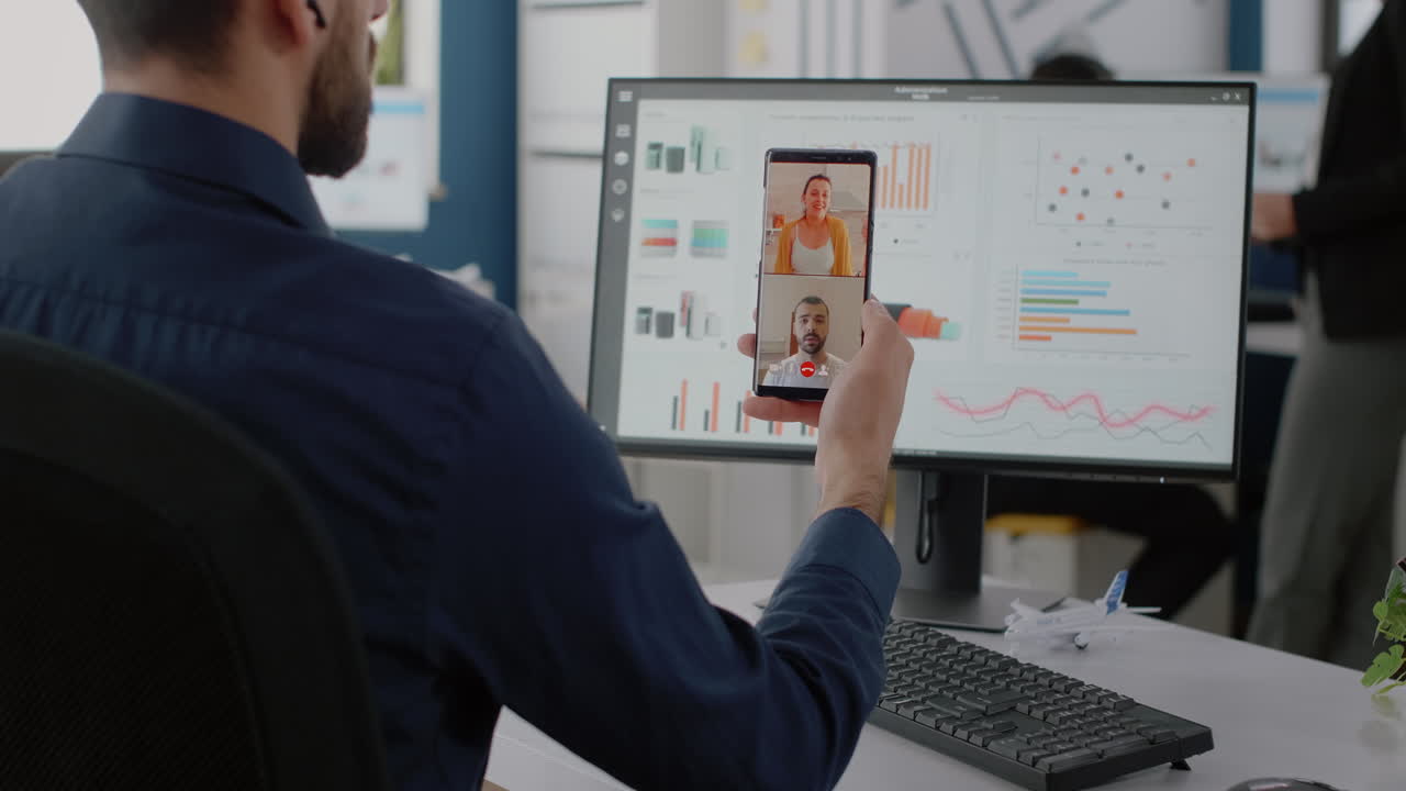 Corporate worker holding smartphone for video call