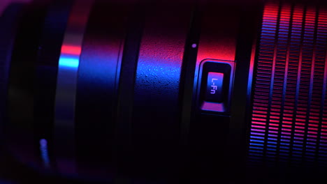 Close-up-camera-lens-function-button-cinematic-red-blue-light-swipe