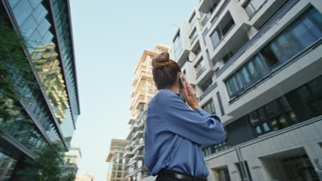 girl ceo talking smartphone on residential area urban district. woman calling