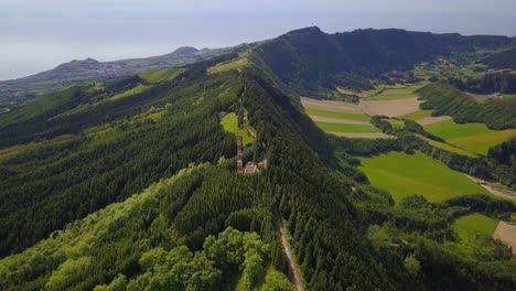 telecommunication tower on top of a lush hill with forest in sao miguel, azores