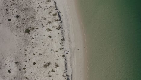 Top-down-view-of-the-perfect-white-sandy-beach-with-breaking-waves