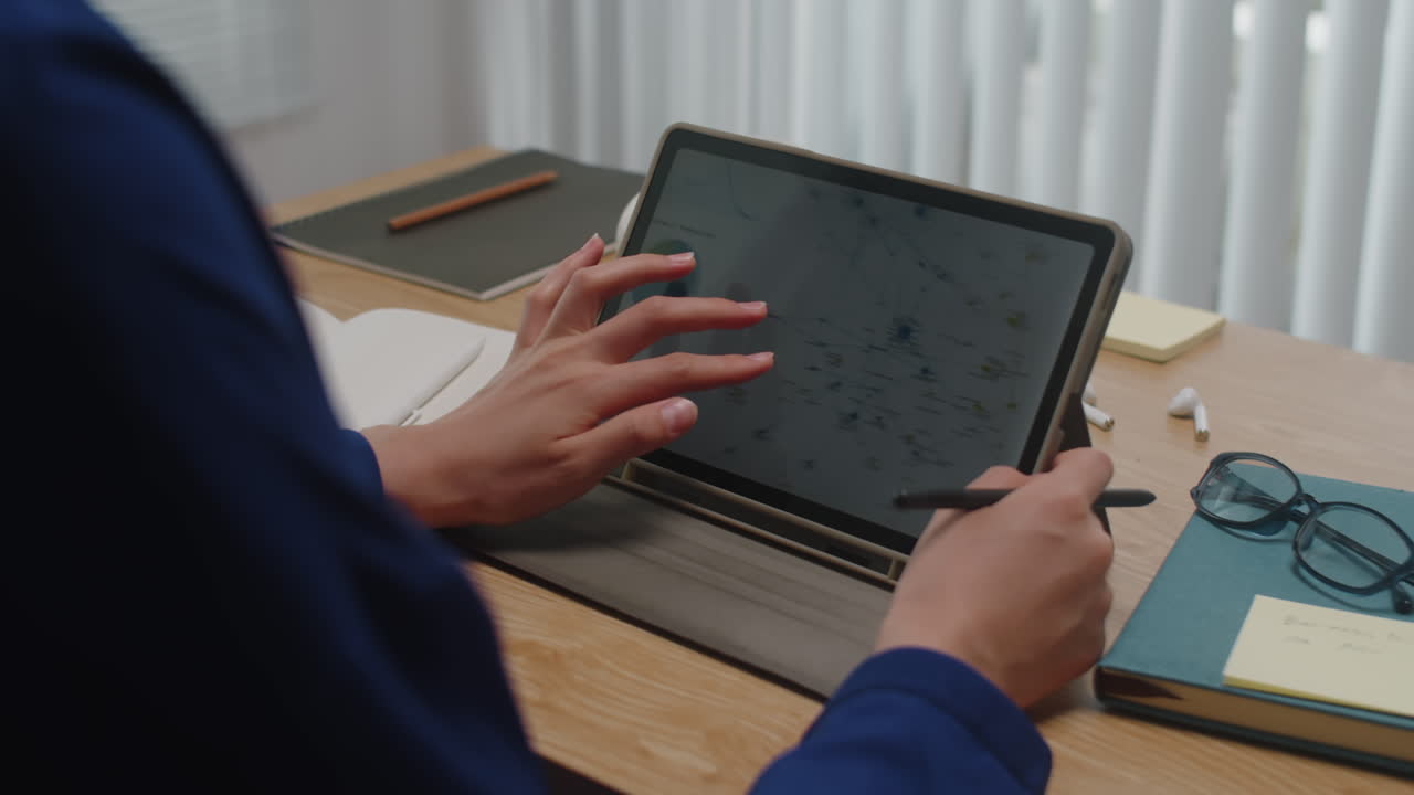 Analyst Working on Tablet Computer at Office