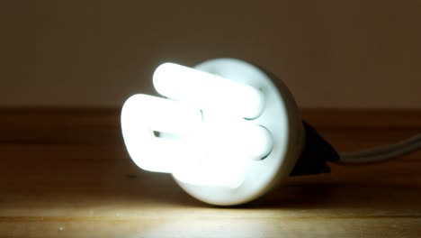 close-up of bulb glowing on a table