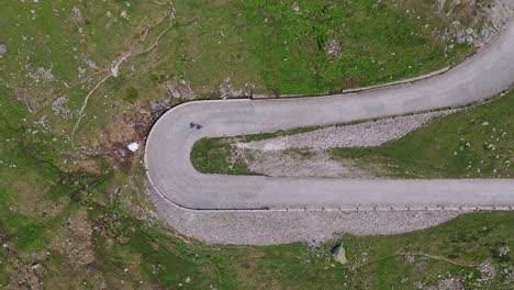 tight aerial overhead shot of a single steep mountain hairpin turn near gotthard pass