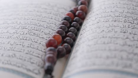 open quran with prayer beads