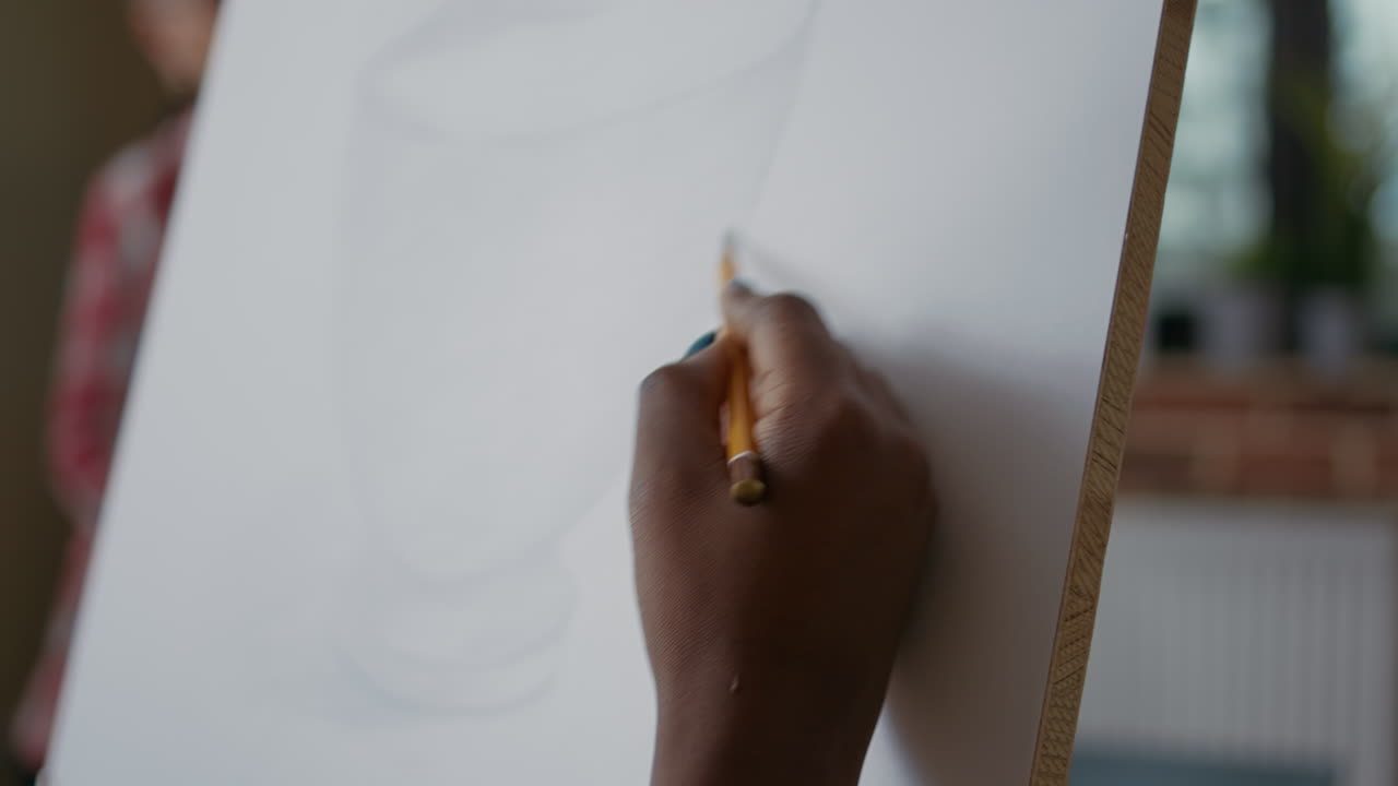 Creative woman using pencil to draw vase model in art class