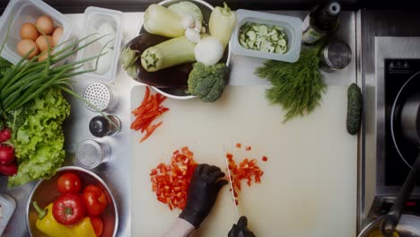 chef chopping red peppers in a kitchen