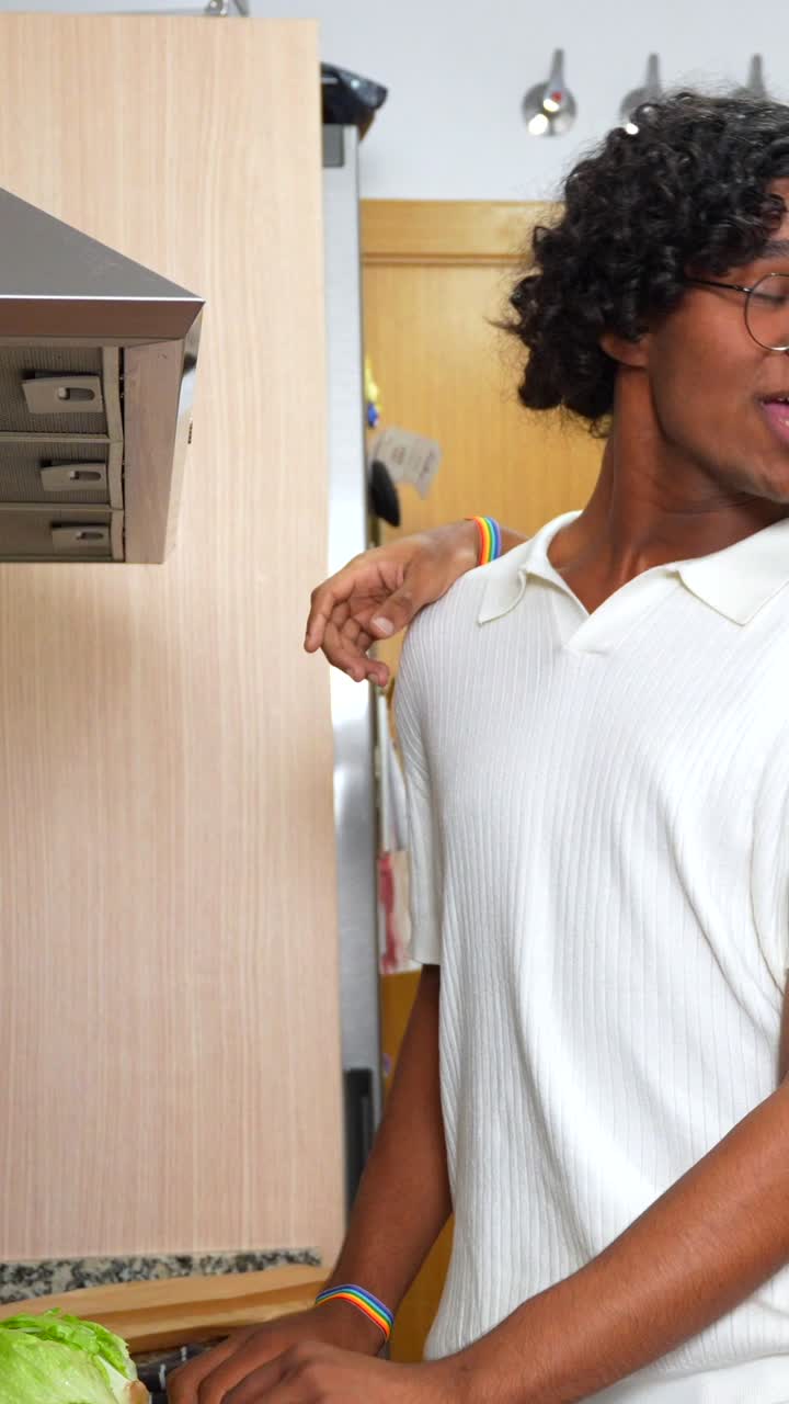 Gay couple cooking together in the kitchen
