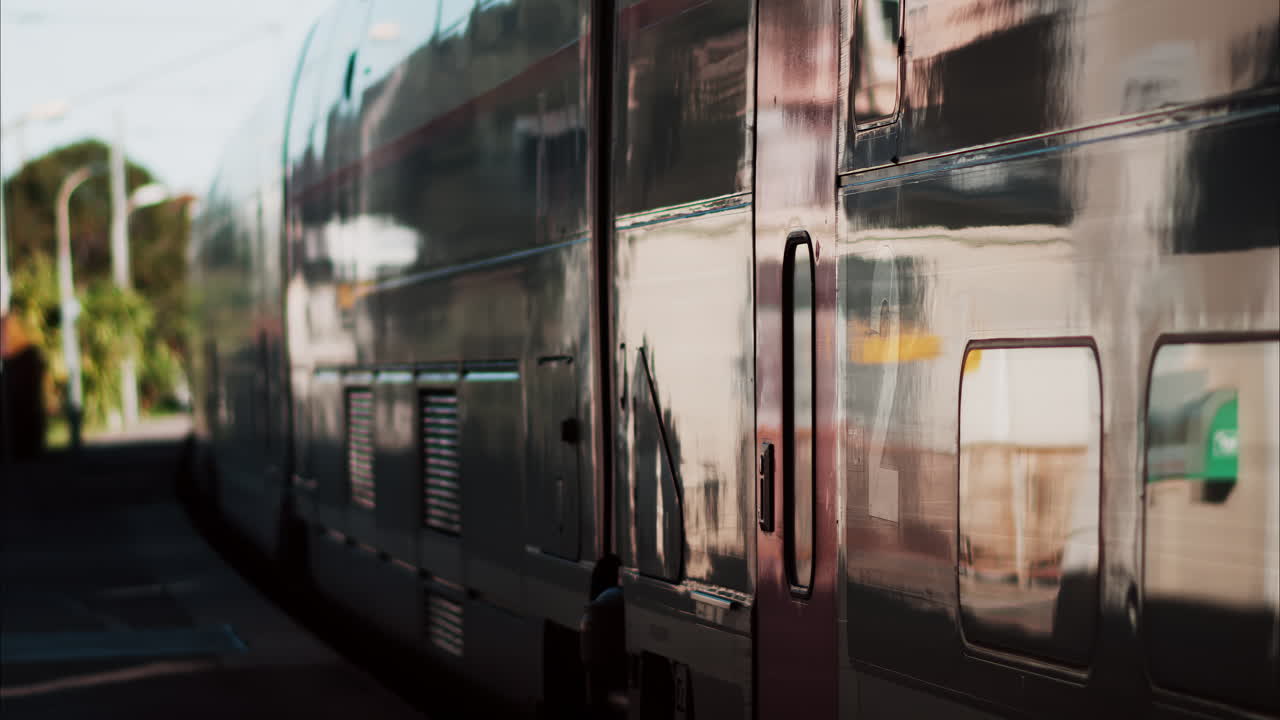 Close up of a train moving on the rails near a station in France