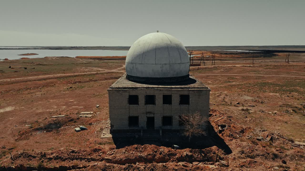 Abandoned Radar Station Building with Dome in Arid Landscape