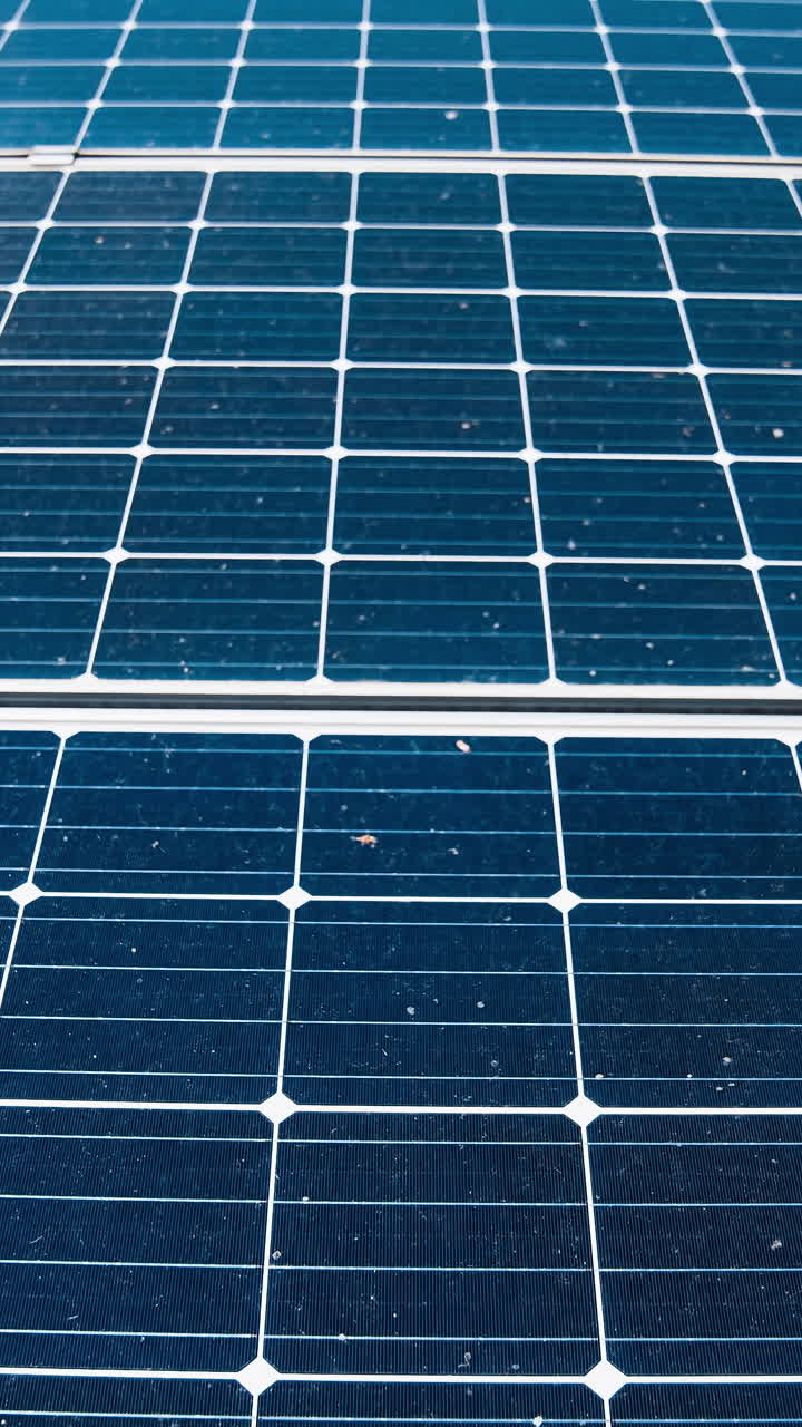 Electrical innovation. Blue photovoltaic panels. Sustainable source of clean energy getting from the sun. Modern sunny batteries. Close-up. Vertical video