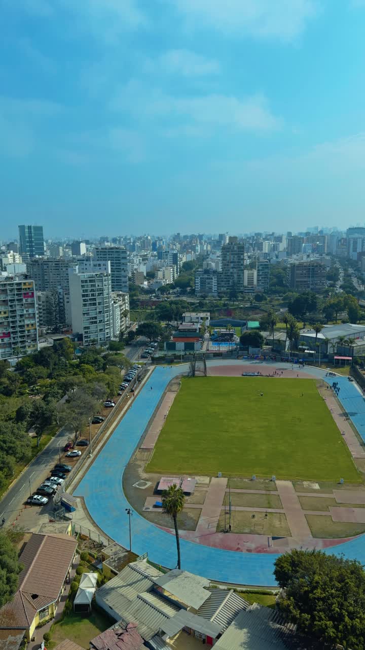 Vertical establishing pan of seaside road, cars driving along coastal path next to ocean and nearby public track