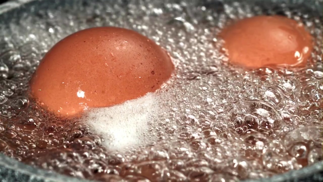 Close-up of Brown Eggs Boiling in Hot Water