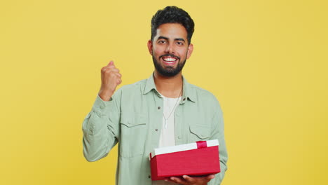 Man-opening-birthday-gift-box-with-red-ribbon,-receiving-great-present-surprise,-celebrating