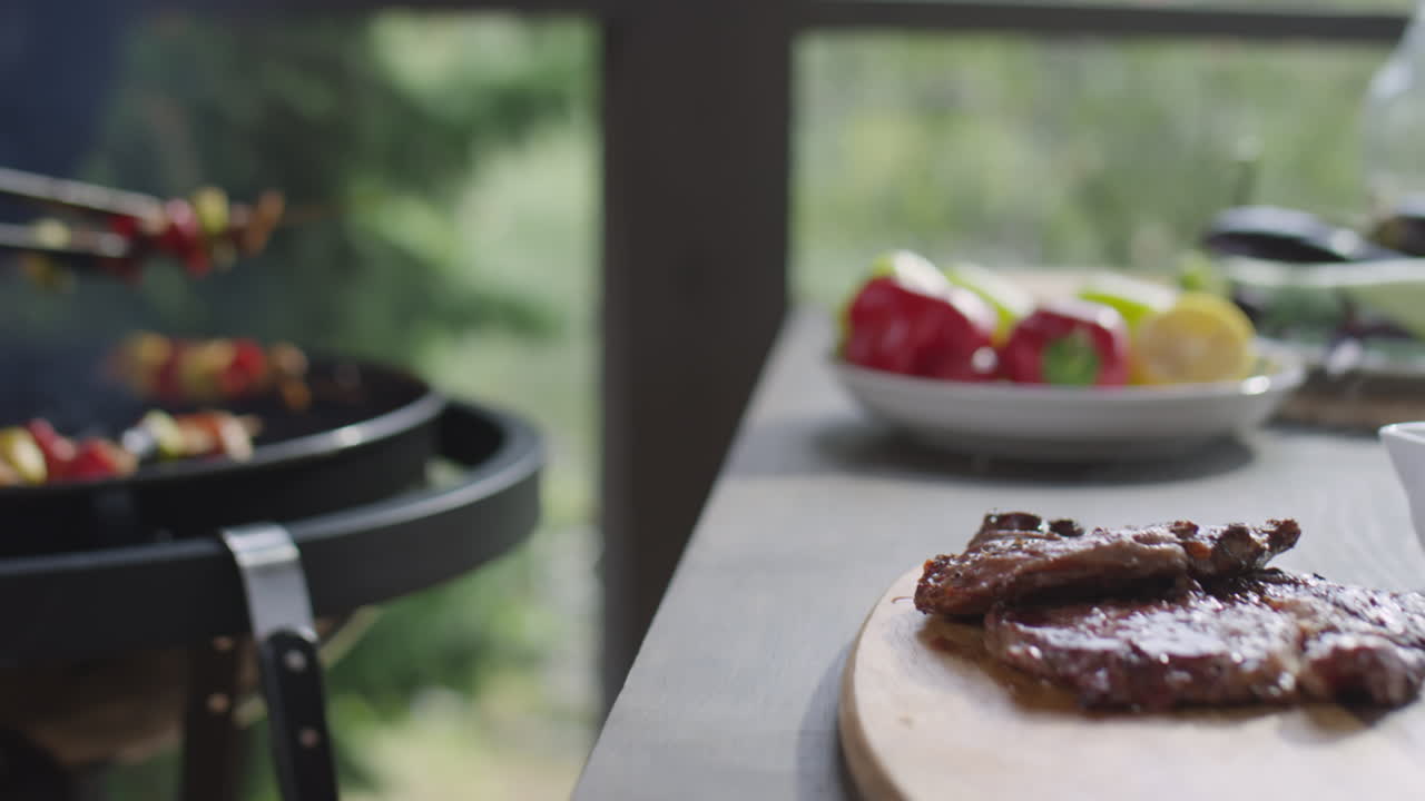 Taking Hot Steaks and Veggie Skewers from BBQ