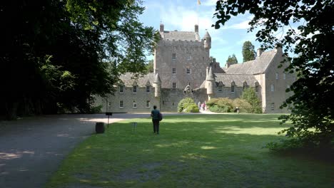 lady walks towards cawdor castle