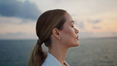 gorgeous businesswoman admiring sea sunset standing shore closeup. woman looking