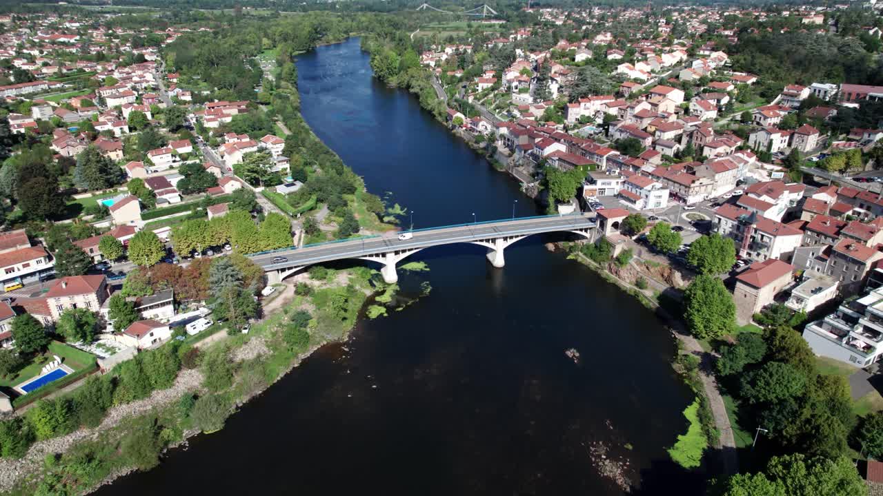 aerial shot above Saint Just Saint Rambert bridge across the Loire river during the day, Loire departement, Auvergne Rhone Alpes region, France