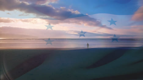 digital composition of honduras flag waving against aerial view of waves in the sea