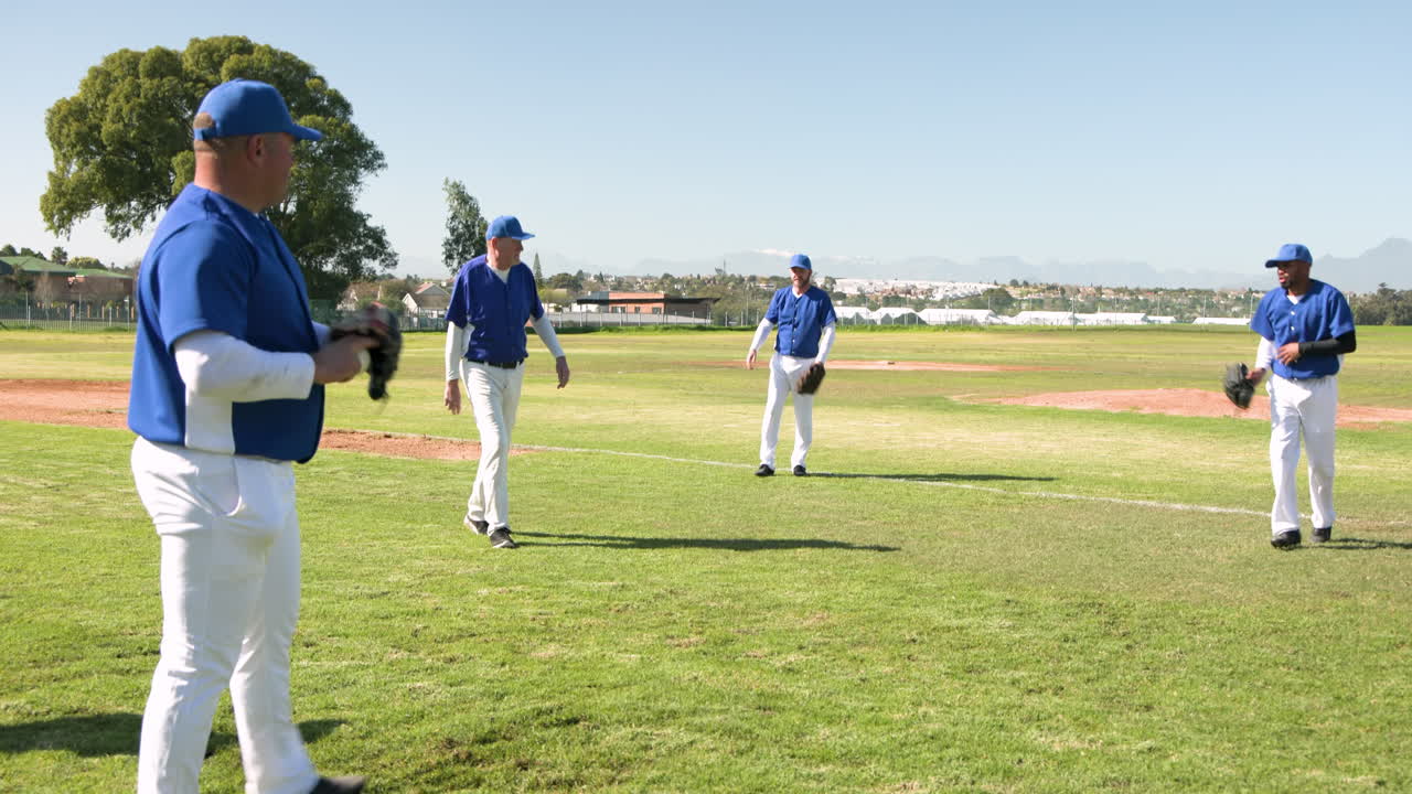 Baseball team in blue uniforms huddling on field, preparing for game