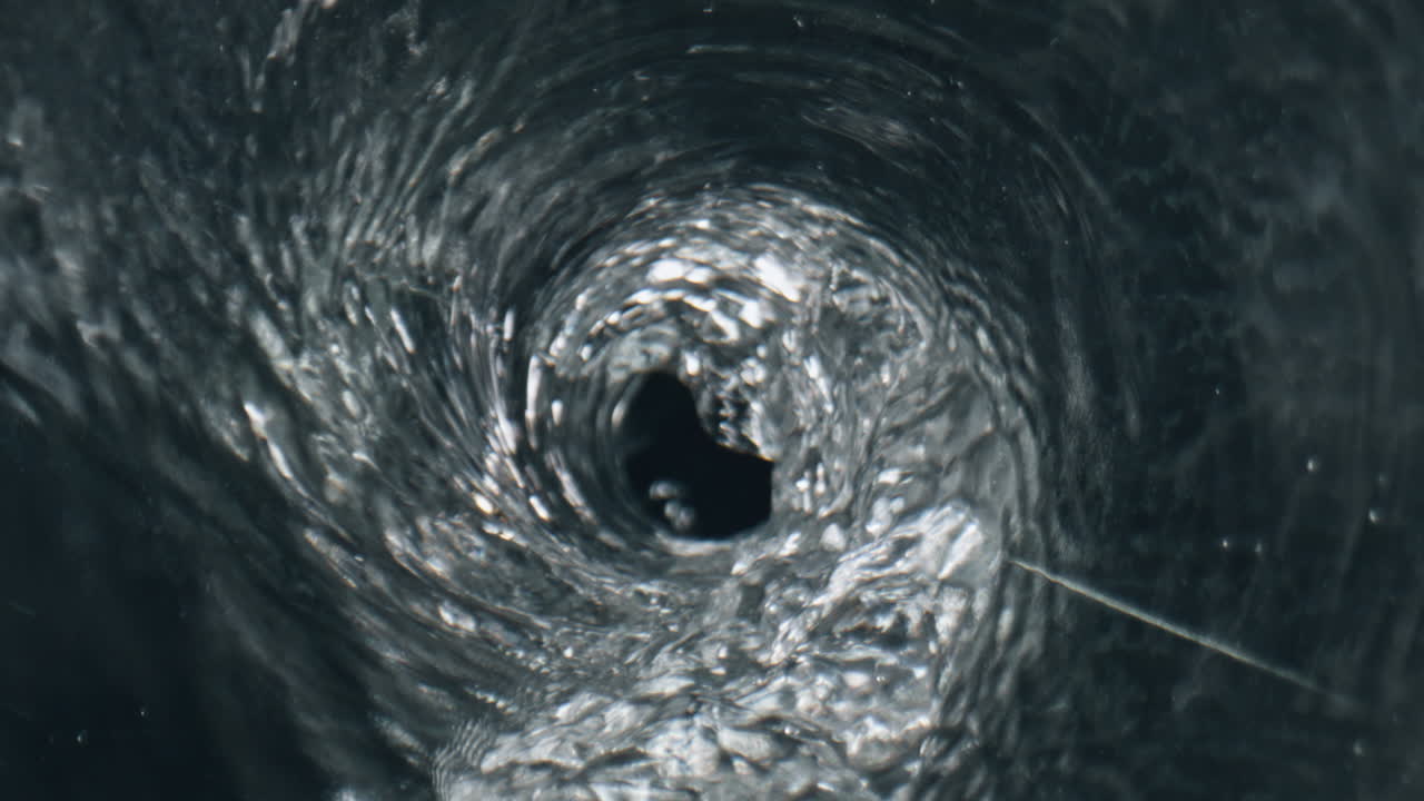 Transparent cocktail making funnel inside glassware. Fresh beverage rotating