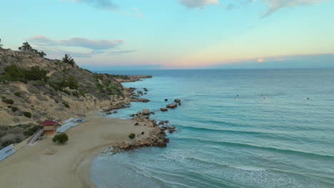 sandy beach, ocean and coastline of cyprus at sunset time