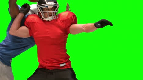 serious american football player tackling for ball