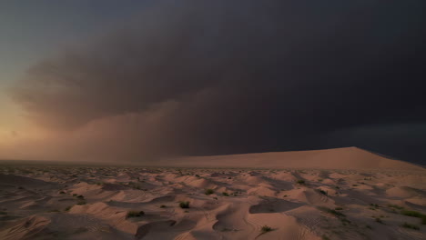 dramatic desert landscape at dawn/dusk with storm clouds