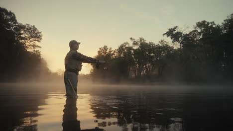 man fly fishing in a misty morning river