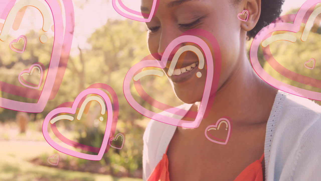Outdoors, woman smiling with pink heart animation overlay in background