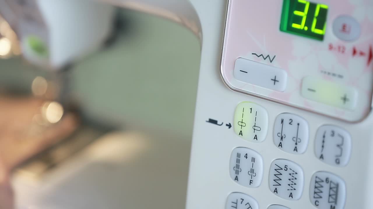 Seamstress at the Table. Close up of sewing machine working part with cloth