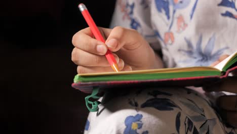 person writing in a notebook