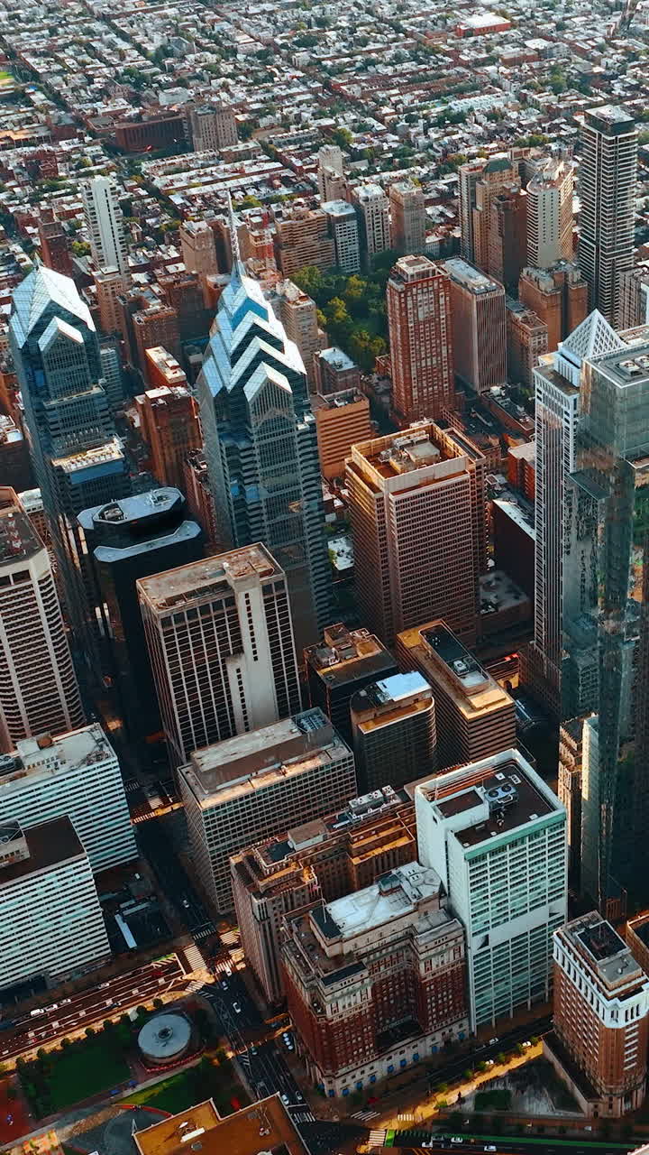 Fascinating buildings in the skyscraper complex of Philadelphia, Pennsylvania, USA. Drone footage above the metropolis panorama at daytime. Vertical video
