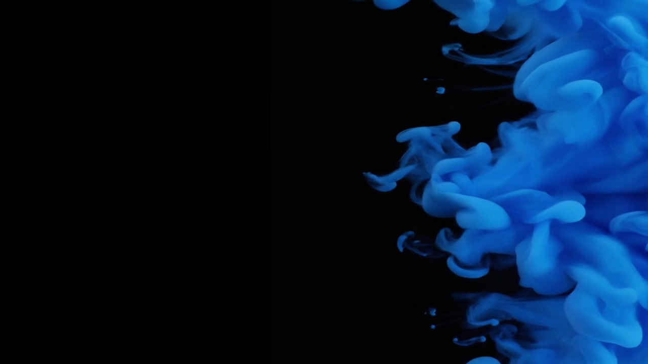 Inchiostro blu che turbina nell'acqua su sfondo nero