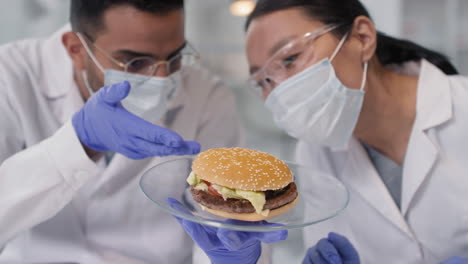 scientists examining a hamburger in a laboratory setting