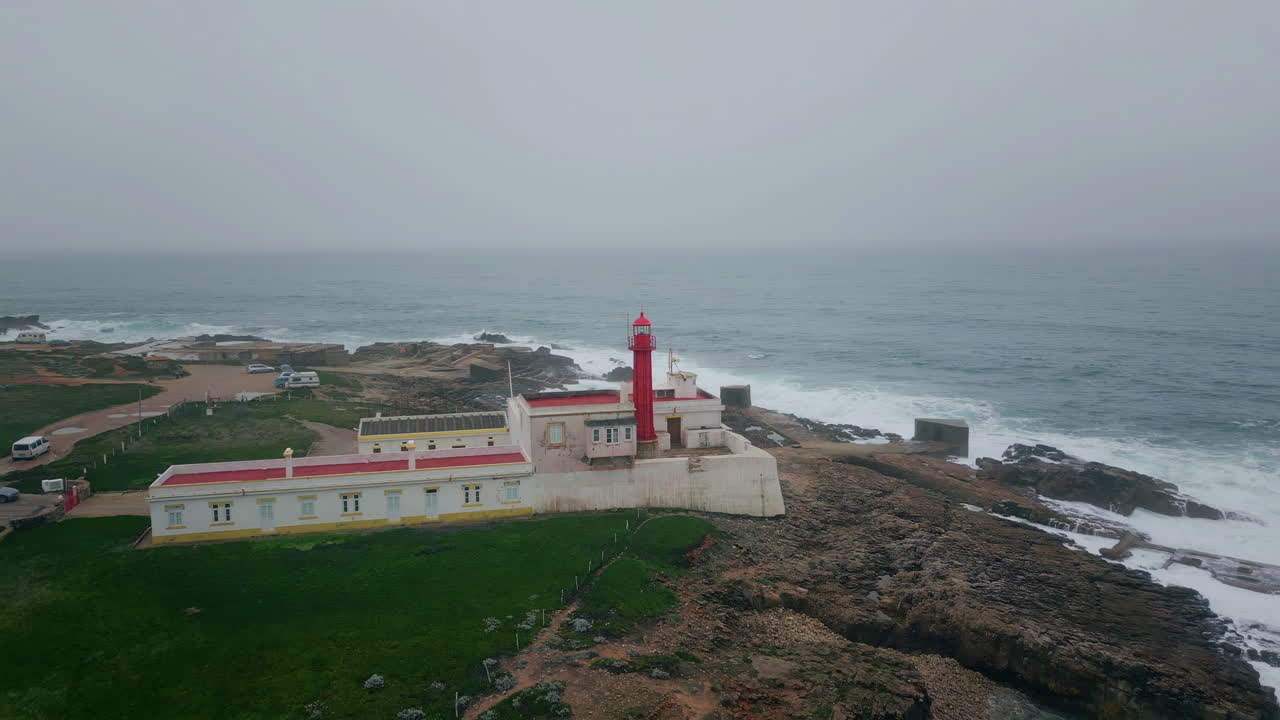 Grey marine horizon lighthouse standing shoreline aerial view. Ocean surface