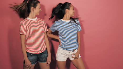 two women posing in striped shirts and shorts