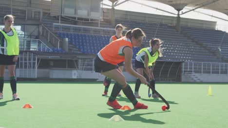 female hockey players training on a field