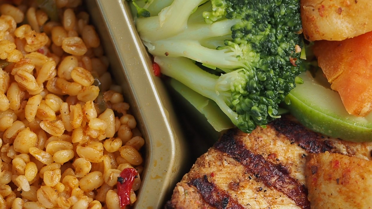 Close-up of Healthy Grilled Chicken Meal with Vegetables and Grains